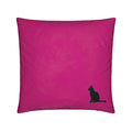 A square magenta pink throw pillow featuring a small black silhouette of a sitting cat in the bottom right corner, set against a plain white background.