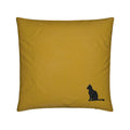 A square mustard yellow throw pillow featuring a small black silhouette of a sitting cat in the bottom right corner, set against a plain white background.