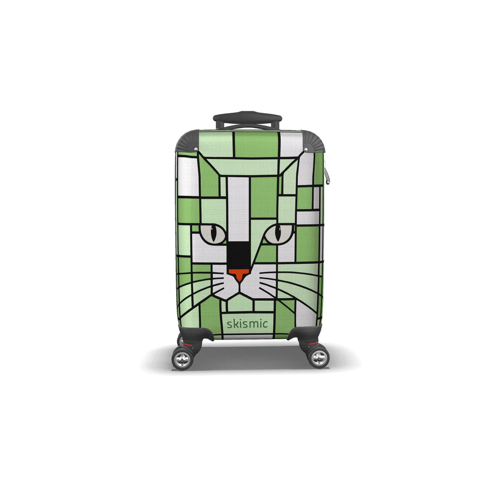 A hard-shell spinner suitcase with a green and white geometric cat face design, featuring the brand name 'skismic' on the front, set against a plain white background.