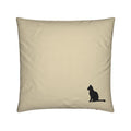 A square beige throw pillow featuring a small black silhouette of a sitting cat in the bottom right corner, shown against a plain white background.
