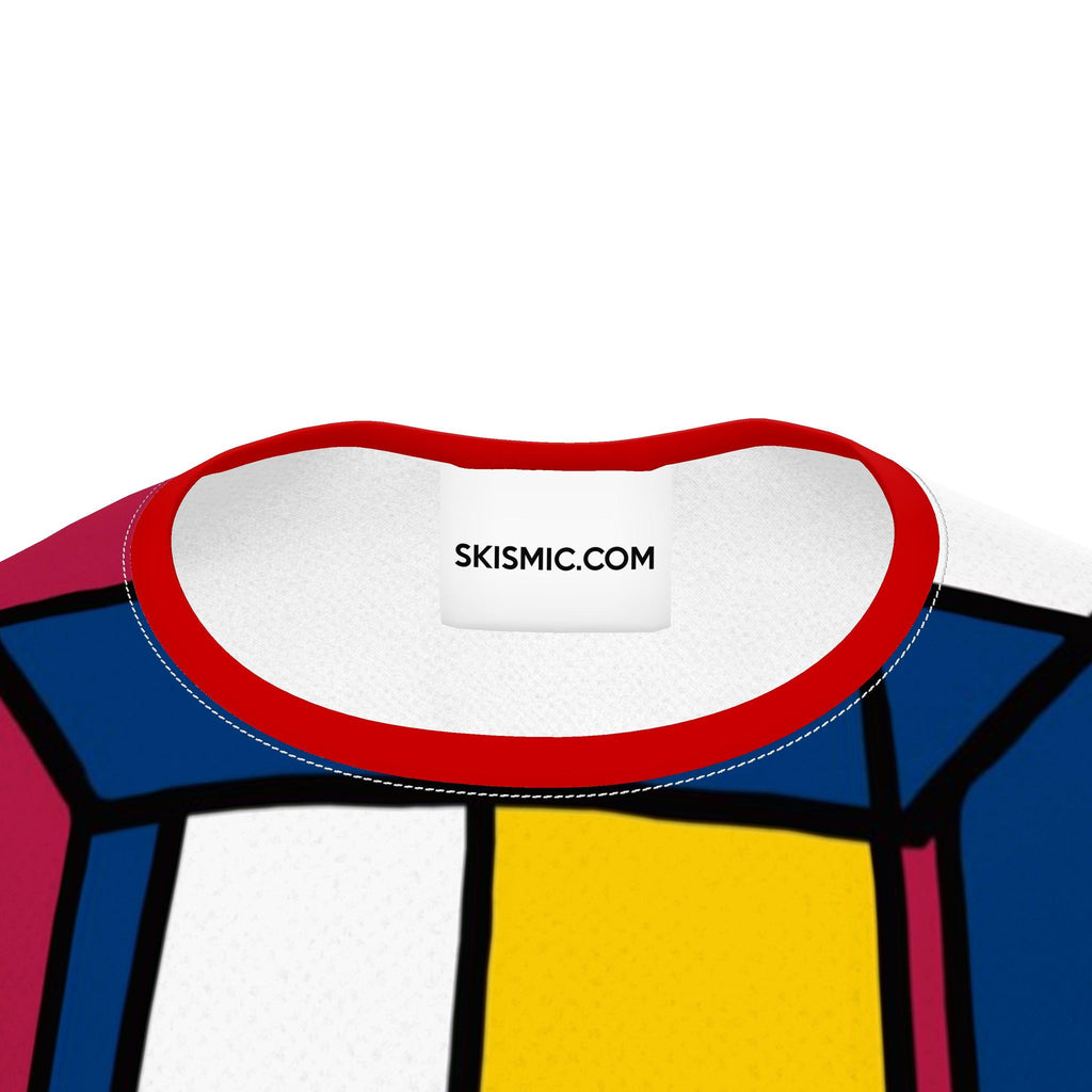 Close-up of the inner neck area of a colorful graphic t-shirt. The collar is white with a red stitched border, featuring the text 'SKISMIC.
