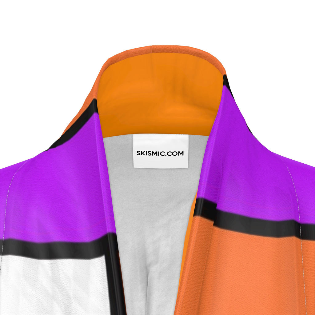 Close-up of a track kimono collar showing a color-blocked design with purple, orange, white, and black panels, featuring a white neck label with the text 'SKISMIC.COM'.