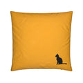 A square amber gold yellow throw pillow featuring a small black silhouette of a sitting cat in the bottom right corner, set against a plain white background.