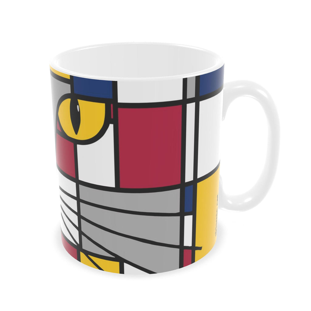 A white ceramic mug featuring a modern, abstract geometric cat face design in a Mondrian-style color block pattern with yellow, red, blue, gray, and black.