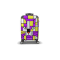 A hard-shell spinner suitcase with a colorful geometric cat face design in purple, yellow, white, and gray, featuring the brand name 'skismic' on the front.