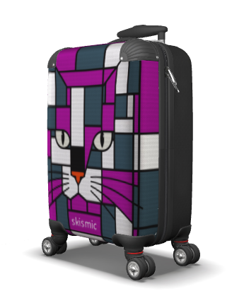 A hard-shell spinner suitcase with a colorful geometric cat face print. The design features a stylized cat face in shades of purple, teal, white, and black, with the word 'skismic' printed near the bottom.