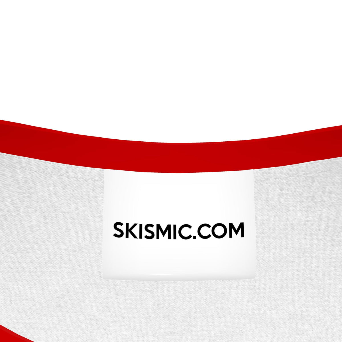 Close-up of a white knit kids t shirt for boys with a bold red curved stripe across the upper portion and a white sewn label reading SKISMIC.COM