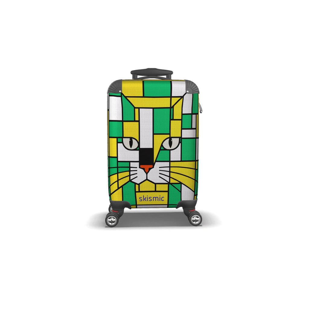 A hard-shell spinner suitcase featuring a colorful geometric cat face design in green, yellow, white, and gray, with the brand name 'skismic' printed near the bottom.